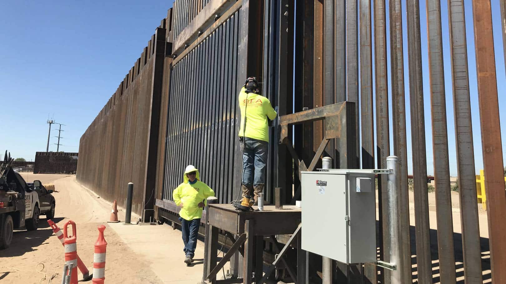 Workers at border wall construction site