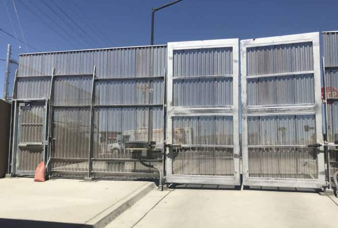 Large metal gates in bright sunlight