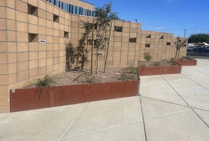 Modern wall with planters and gravel.