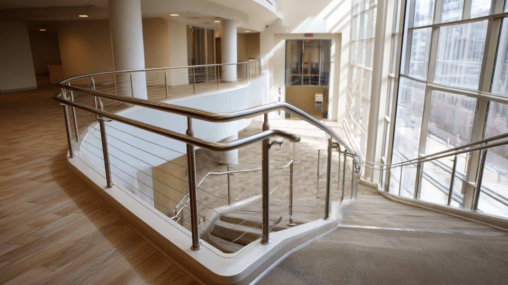 Modern staircase with sleek handrail.